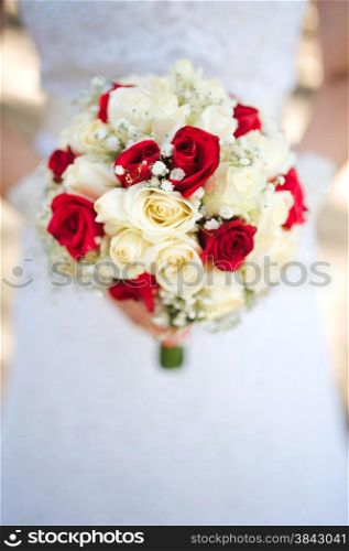 Bride holding a bouquet of roses
