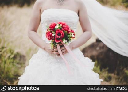 Bride holding big wedding bouquet on wedding ceremony.