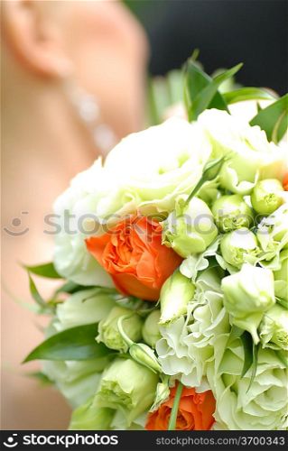 bride holding bouquet from roses