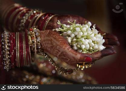 Bride holding jasmine flower