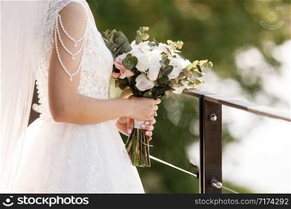 bride holds a bouquet of pink and white flowers.. bride holds a bouquet of pink and white flowers