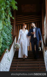 bride in a white dress with a bouquet and the groom in a blue suit on their wedding day