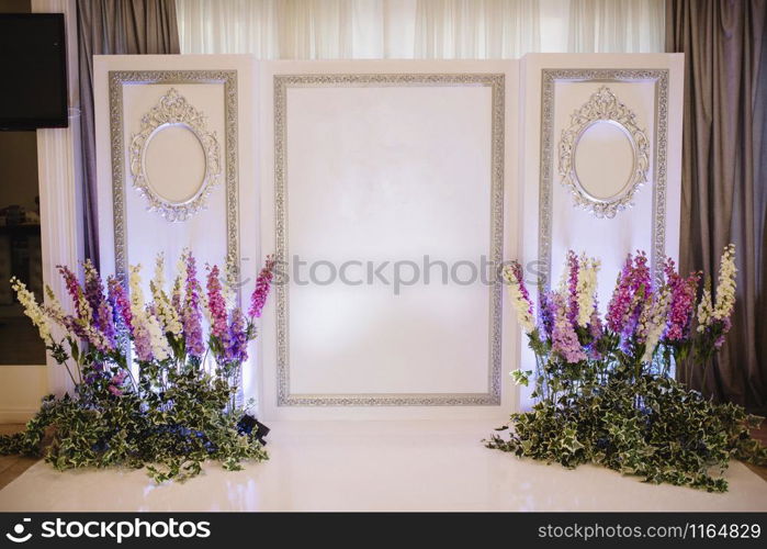 Bride in a white wedding dress holding wedding shoes. Bride in a white wedding dress holding wedding shoes in her hands