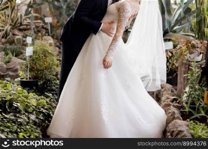 bride in a white wedding dress with the groom in a suit. the bride in a white wedding dress with the groom in a suit