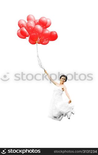 bride in white dress with balloons on green field
