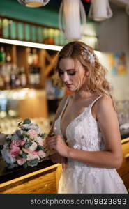 bride inside the cocktail bar at the bar in a bright atmosphere