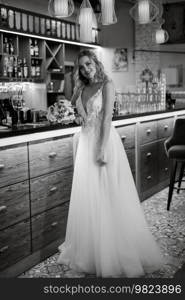 bride inside the cocktail bar at the bar in a bright atmosphere