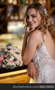 bride inside the cocktail bar at the bar in a bright atmosphere