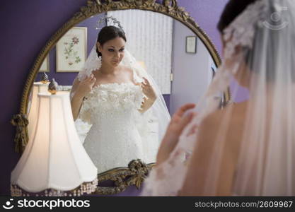 Bride looking in mirror