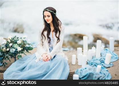 bride on the background of a mountain waterfall