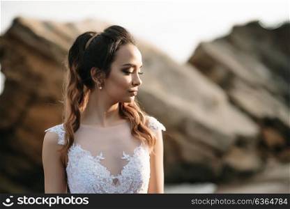 bride on the shore of the black sea in the sunset light