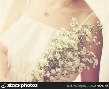 Bride or bridemaid with bouquet, closeup with retro filter effect