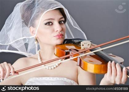 Bride playing violin in studio