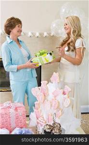 Bride receiving gift from friend at Bridal Shower