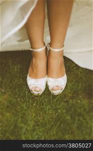 Bride&rsquo;s White Shoes on a Grass Field