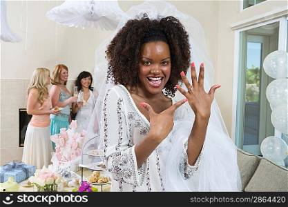 Bride showing her engagement ring at bridal shower