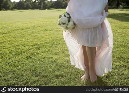 Bride standing on grass