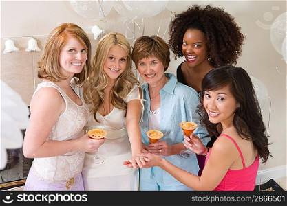 Bride standing together with friends showing engagement ring