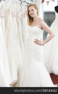 Bride Trying On Wedding Dress In Bridal Boutique