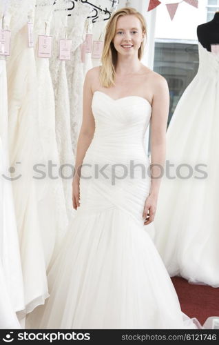 Bride Trying On Wedding Dress In Bridal Boutique