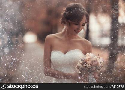 Bride with a bouquet of flowers in a white dress at a wedding