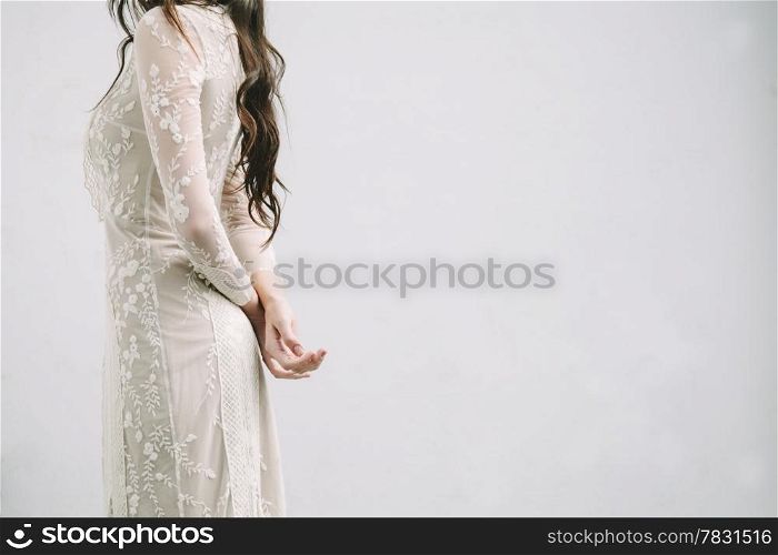 Bride with Arms Crossed on a White Background