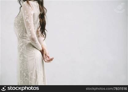 Bride with Arms Crossed on a White Background