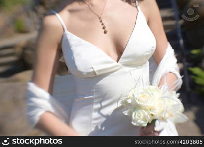 Bride with Bouquet of White Roses and Orchid