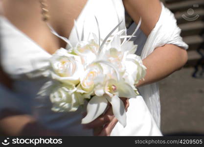 Bride with Bouquet of White Roses and Orchid