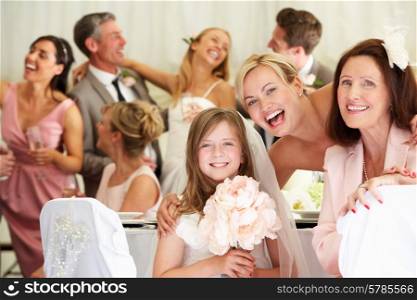 Bride With Grandmother And Bridesmaid At Wedding Reception