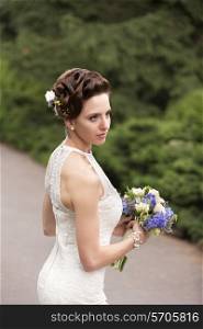Bride with wedding bouquet in hand, closeup view&#xA;