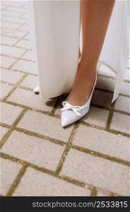 Bride with White Shoes on Feet. Festive Wedding Fashion Concept. High quality photo.. Bride with White Shoes on Feet. Festive Wedding Fashion Concept. High quality photo