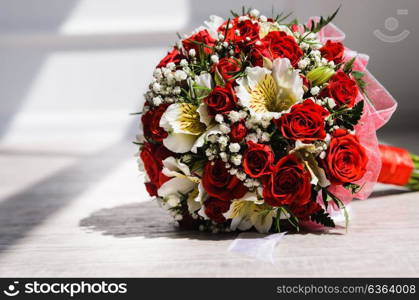 brides bouquet on a vintage wooden floor in the sunlight