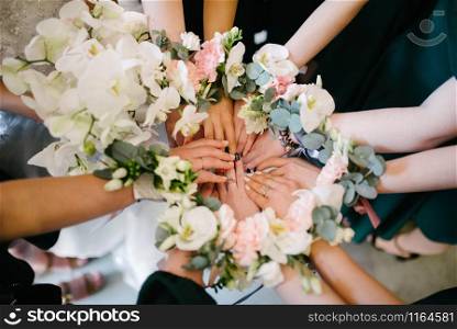 Bridesmaids bridesmaids from flowers on hands. Bridesmaids bridesmaids from flowers on their hands