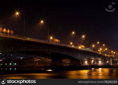 Bridge across the river. Automobile bridge across the river. The light from the lamp beside the bridge.