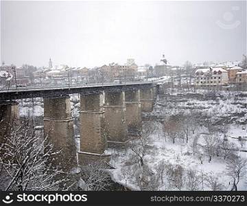 Bridge across the river under snow in winter