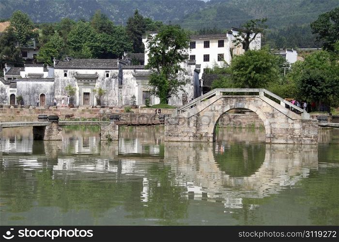 Bridge and buildings on the lake in Shexian town, China