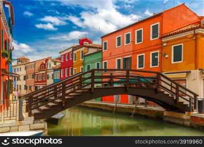 Bridge and canal with colorful houses on the famous island Burano, Venice, Italy