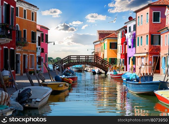 Bridge and colored houses on the street in Burano, Italy