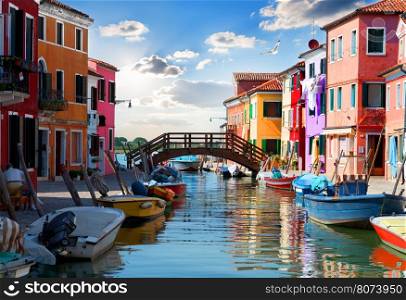 Bridge and colored houses on the street in Burano, Italy