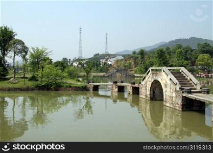Bridge and park on the lake in Shexian town, China