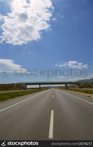 Bridge and road horizon front perspective view in a sunny blue sky