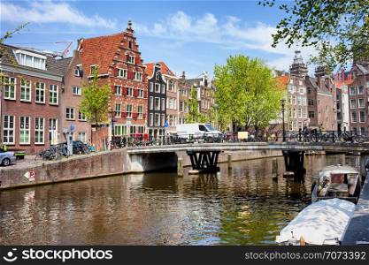 Bridge and traditional Dutch houses on Oudezijds Voorburgwal canal, city of Amsterdam, Netherlands.