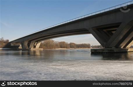 bridge crossing the river with ice in the winter