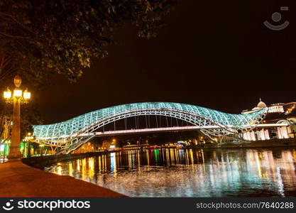 Bridge of Peace, modern pedestrian bridge over the Mtkvari River in the center of Tbilisi at night