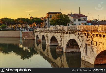 Bridge of Tiberius in Rimini at sunset, Italy.