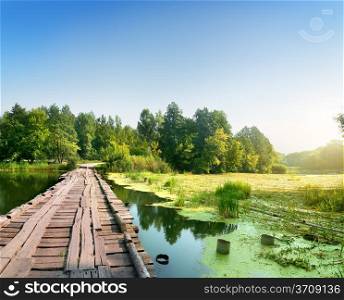 Bridge over a swampy river on sunrise