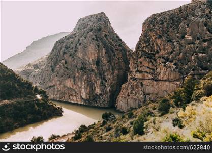 Bridge over de river among rock mountains in south of Spain and runway on the rock mountains