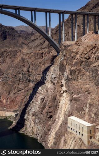 Bridge over river Colorado with steep hillside in Canyon