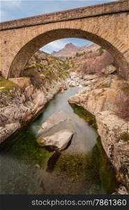Bridge over the Golo river near Albertacce in central Corsica with Mount Albanu in the distance